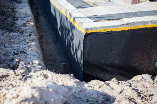 Professional Basement Waterproofing technician working in Rothbury, MI